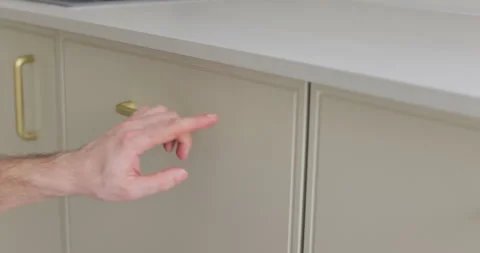 Handyman installing and adjusting drawer slide mechanism in contemporary kitchen 库存影片 329763633