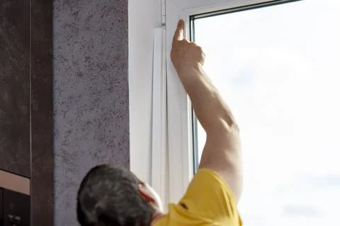 Handyman measuring a window 写真素材