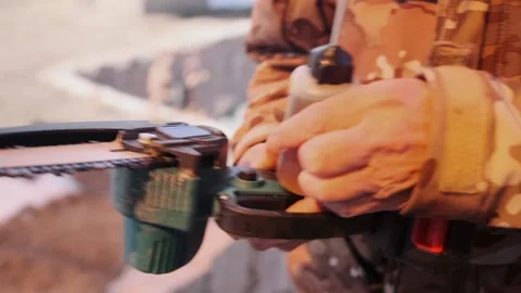Handyman Oils And Adjusts Chainsaw In Yard, Individual Servicing Mini Chainsaw Stock Footage 326865879