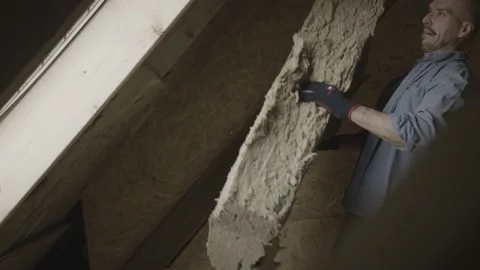 Handyman putting insolation in a wall Stock Footage 149292197