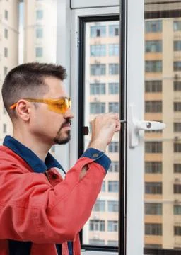 Handyman setting up a window. Setting up new windows Stock Photos