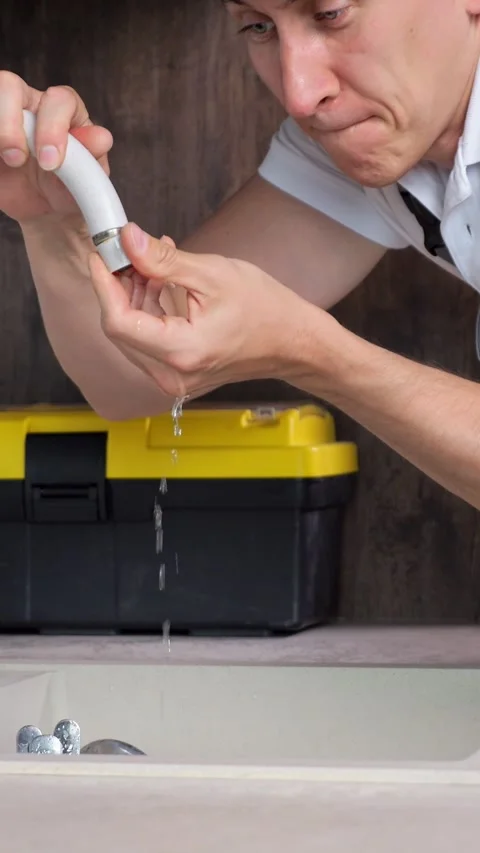 Handyman Struggles With Dripping Water Pipe Near Washbasin With Funny Strained Stock Footage 346989403