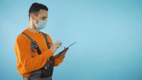 Handyman with tablet isolated on blue backgound with copy space studio shot Stock Footage 140982169