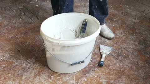 Handyman taking can with paint while renovating house Stock Footage 71477034