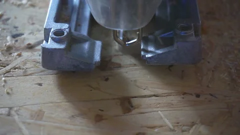 	Handyman using an automatic hand saw on the desk of a wooden workshop. Stock Footage 97716560