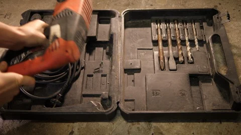 Handyman using big old wired electric rusty Drilling tool in protective box. POV Stock Footage 126340339