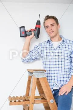 Handyman using cordless drill to the ceiling Stock Photos
