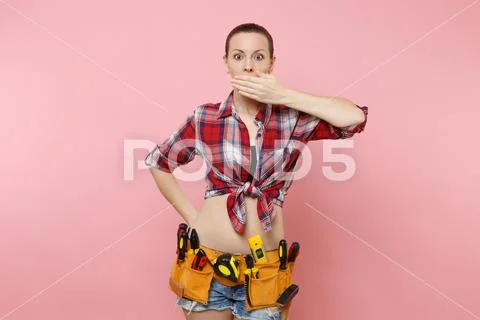 Handyman woman in shirt, denim shorts, kit tools belt full of variety useful Stock Photos