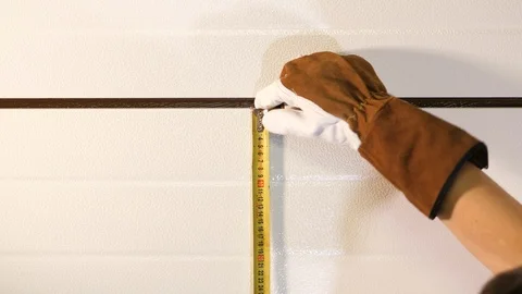 Handyman worker measuring wall with tape Meter tool device. Wearing brown gloves Stock Footage 126334956