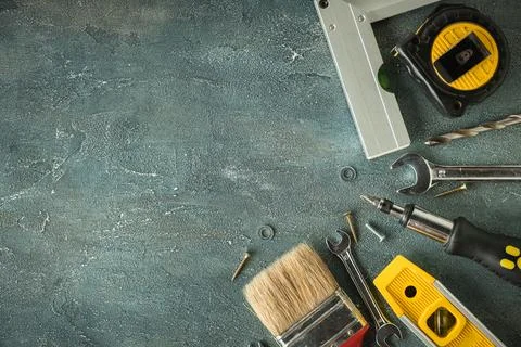 Handyman's tools. Flat lay of clamps, wrench, screwdriver, drill, angle, bubb Stock Photos