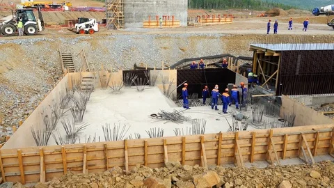 Handymen perform reinforcement of the foundation in the pit for the building Stock Footage 73822862