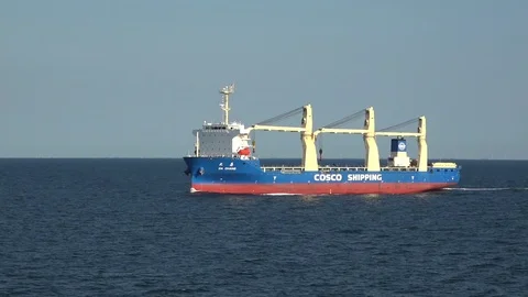 Handysize ship with red and blue flank sails among ocean Stock Footage 113093669