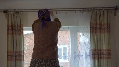 Hang the curtains Video stock 244634781