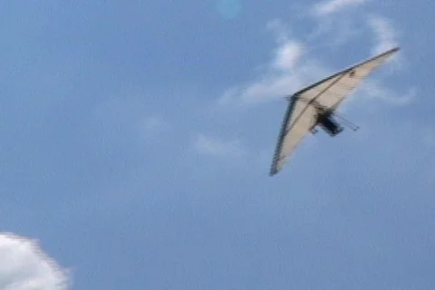 Hang Glider Circles to Land  Stock Footage 145366