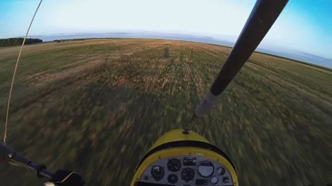 The hang glider is extremely low flying over the field Stock Footage 197406030