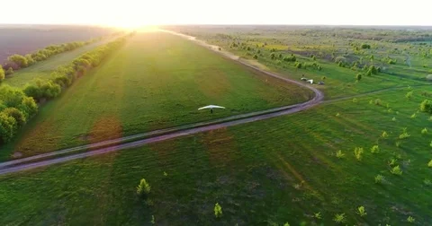 Hang glider flight in sunset time Stock Footage 83750334
