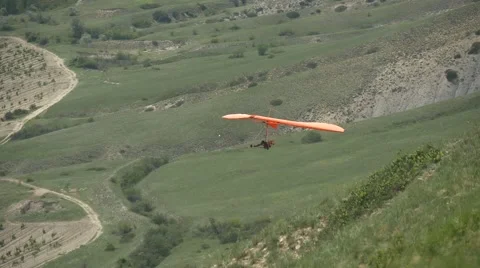Hang glider flying in the background of grape fields Stock Footage 64591239