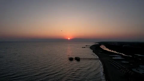 Hang glider flying over the sea at sunset drone shot Stock Footage 255908207