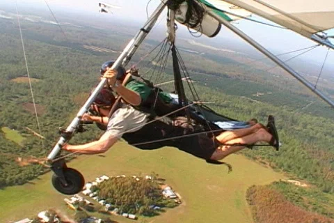Hang Glider Passes Another Mid-Flight Aerial Hang Gliding Stock Footage 145343