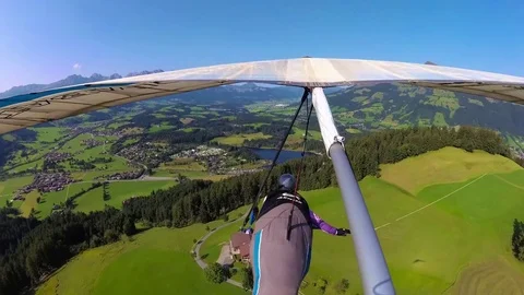  Hang glider pilot flies over Kitzbuhel ski resort Stock Footage 79930594