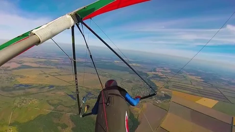 Hang glider pilot fly high over ground Stock Footage 81637297