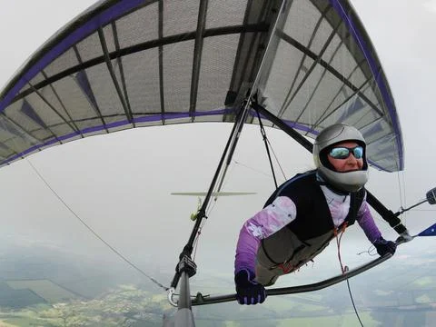 Hang glider pilot under the cloud 写真素材