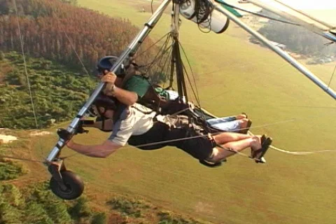 Hang Glider Rotates Over Tree Tops Woods Forest Tandem Hang Gliding Aerial  Stock Footage 145342