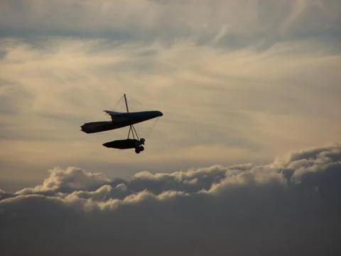 Hang Glider Soaring Through the Clouds Stock Photos