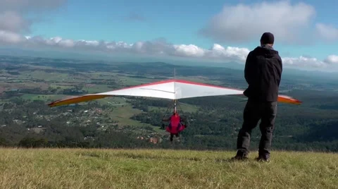 Hang gliders take off from a mountain top Stock Footage 41854329