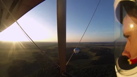 Hang gliding around a balloon at sunset Stock Footage 197406223