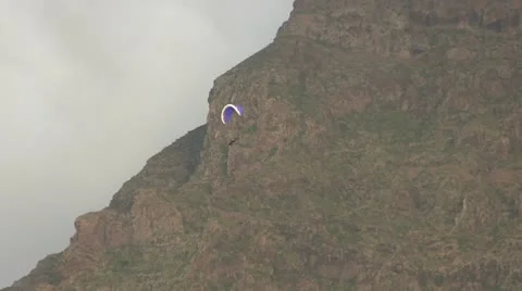 Hang Gliding near a cloudy mountain. Stock Footage 14562736