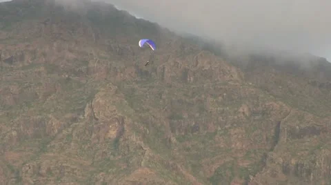 Hang Gliding near a cloudy mountain. Stock Footage 14564457