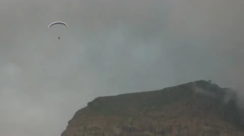 Hang Gliding near a cloudy mountain. Stock Footage 14565216