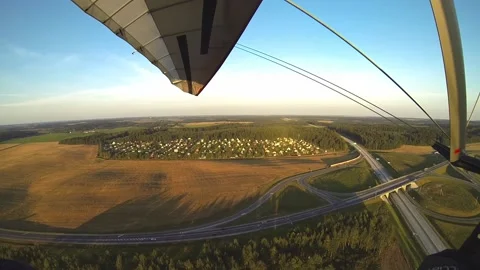 Hang gliding over the highway Stock Footage 197406098