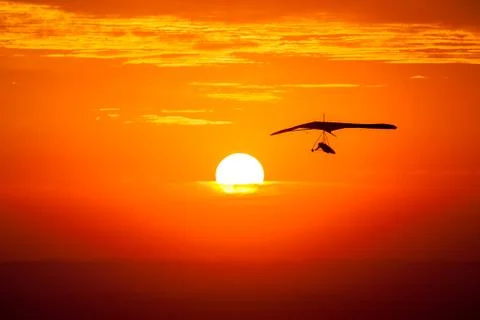 Hang gliding in the sunset Stock Photos