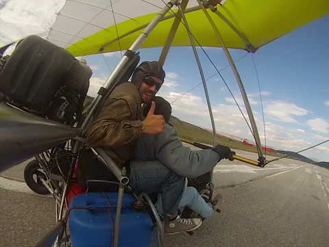 Hang Gliding take off tandem flying above fields and forests. Stock Footage 54095937