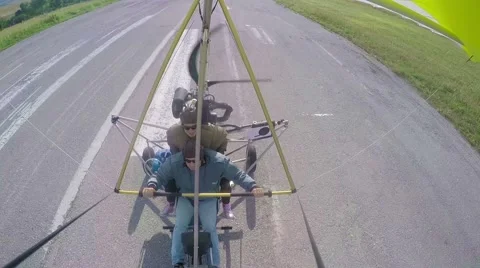 Hang Gliding take off tandem flying above fields and forests. Stock Footage 54096977