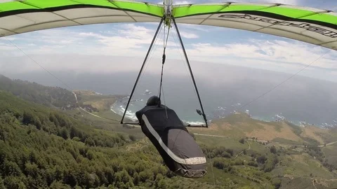 Hang Gliding towards Pacific Ocean coastline Stock-Footage 76677934