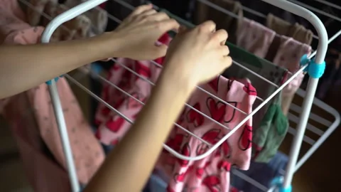 Hang laundry on the dryer. Using a clothes dryer. Top view Stock Footage 267025468