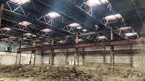 The hangar is destroyed, the suns rays pass through the holes in the roof. Stock Footage 310950949