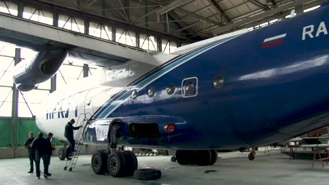 In hangar in the foreground An-12BK with tail number RA-11310 of Irkut airline. Stock Footage 173025231
