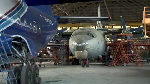 In hangar in the foreground An-12BK with tail number RA-11310 of Irkut airline. Stock Footage 173025349