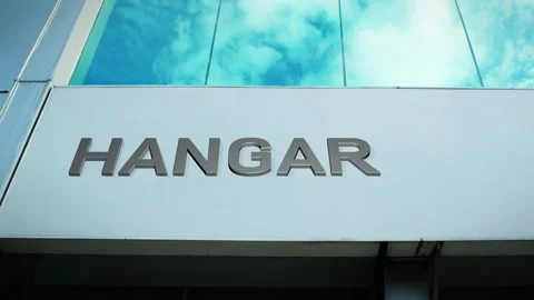 Hangar Sign on Modern Building with Cloud Reflection on Windows Glass Stock Footage 303559336