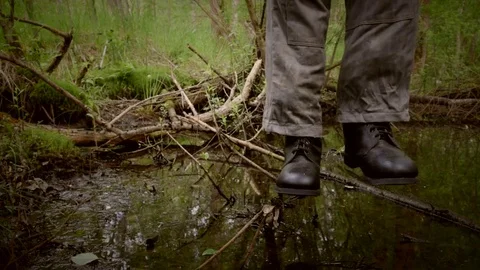 Hanged man in boots over the rotten swamp Stock Footage 77485899