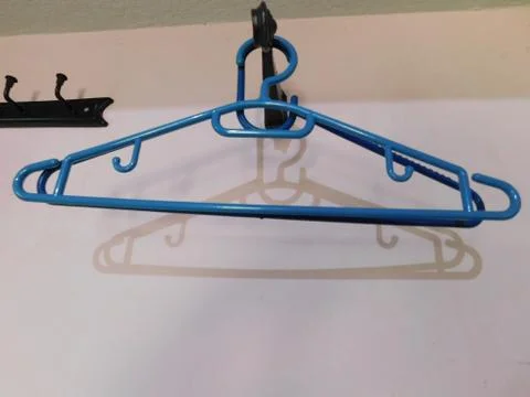 A hanger and its shadow on a wall Stock Illustration