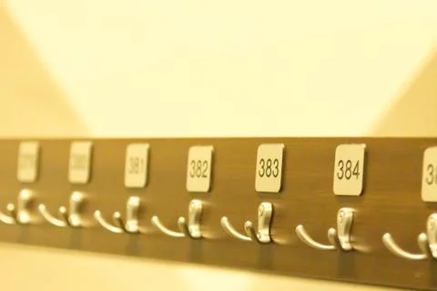 Hanger with hooks for clothes with numbers Stock Photos