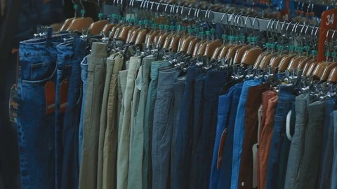 Hanger with jeans in the store Stock Footage 83215031
