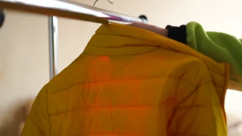 Hanger with a yellow jacket Stock Footage 171765699