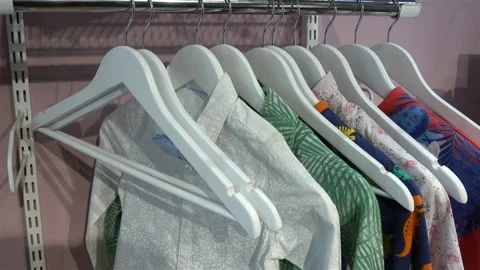 Hangers with clothes and empty on a rack in 4K Video stock 129333591