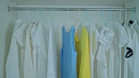 Hangers with clothes in closet Stock Footage 228597761